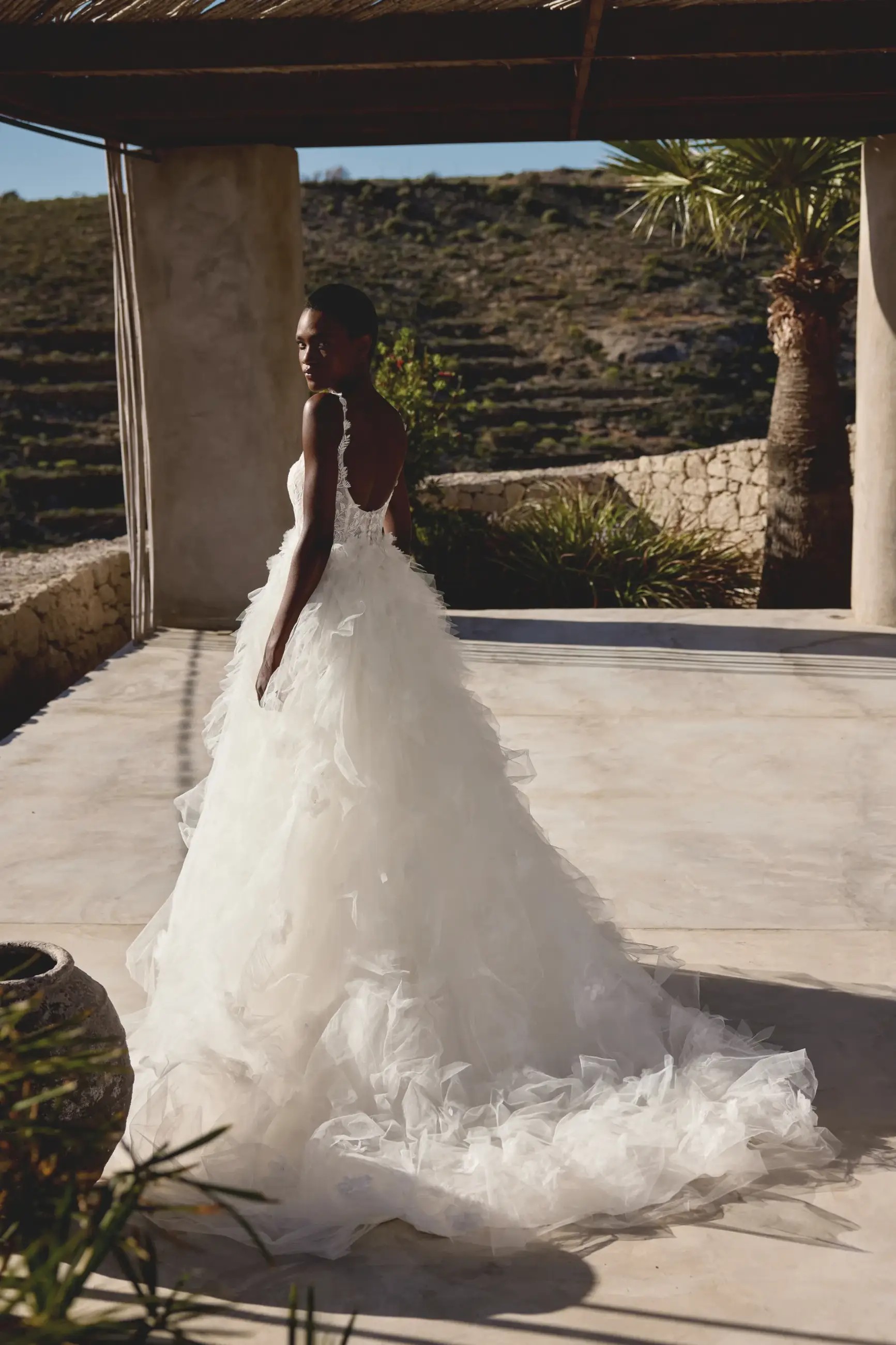 Model is wearing a shimmery tulle wedding dress by lillian west