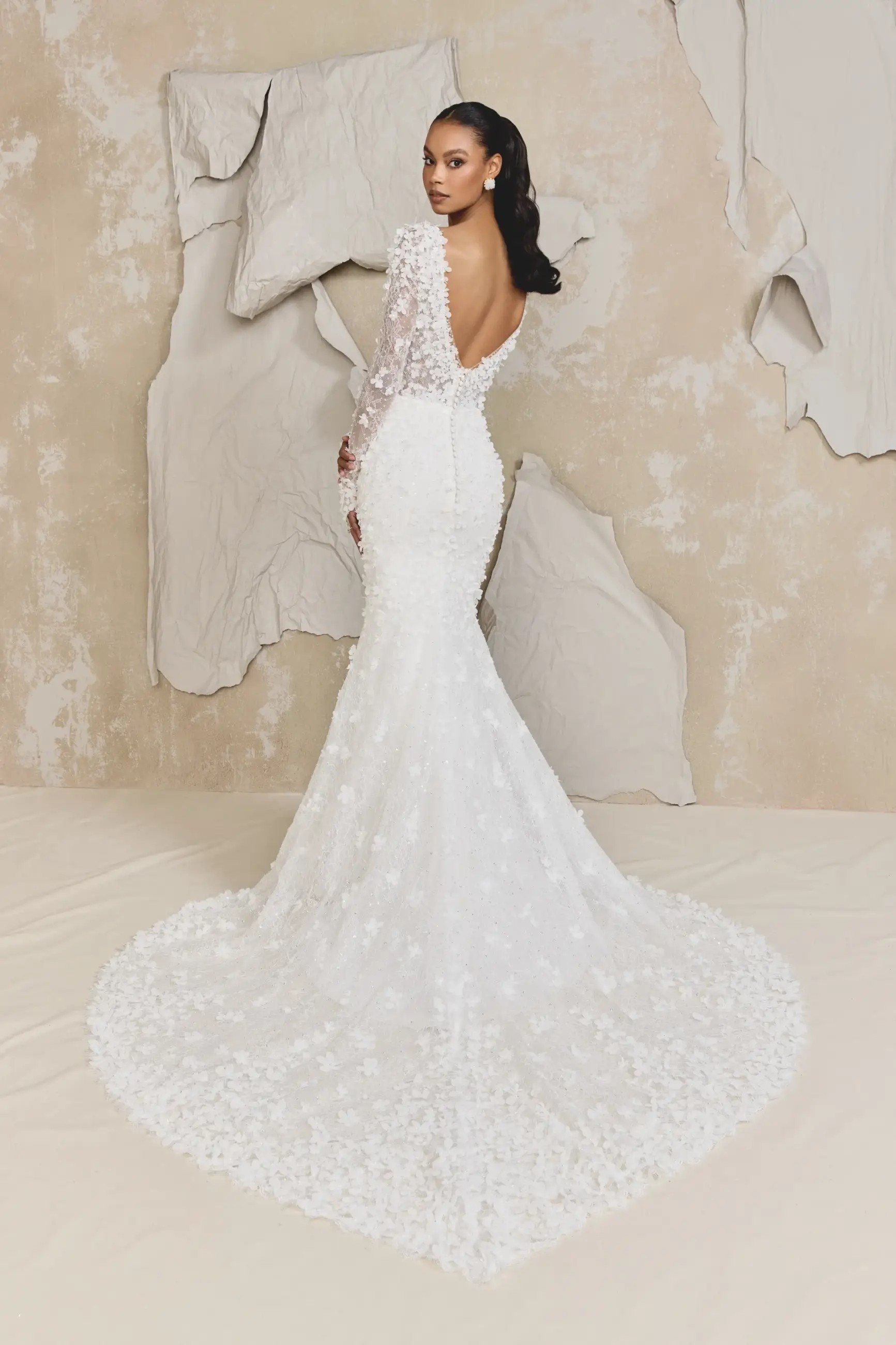 Model is wearing a glitter tulle fit and flare wedding dress by justin alexander signature