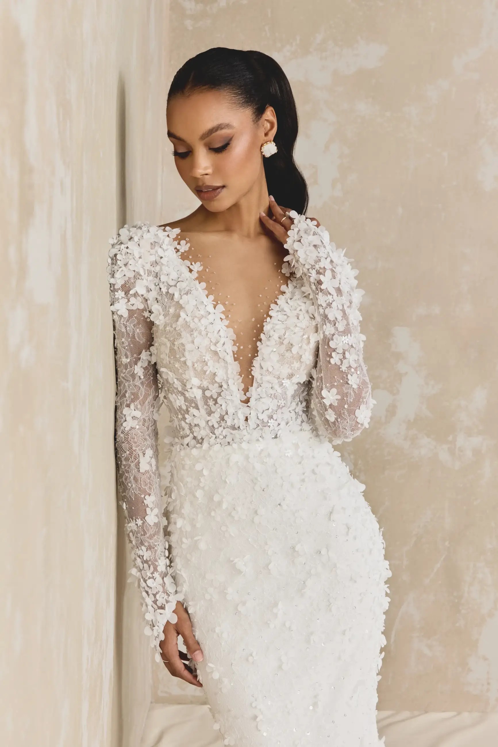 Model is wearing a glitter tulle fit and flare wedding dress by justin alexander signature